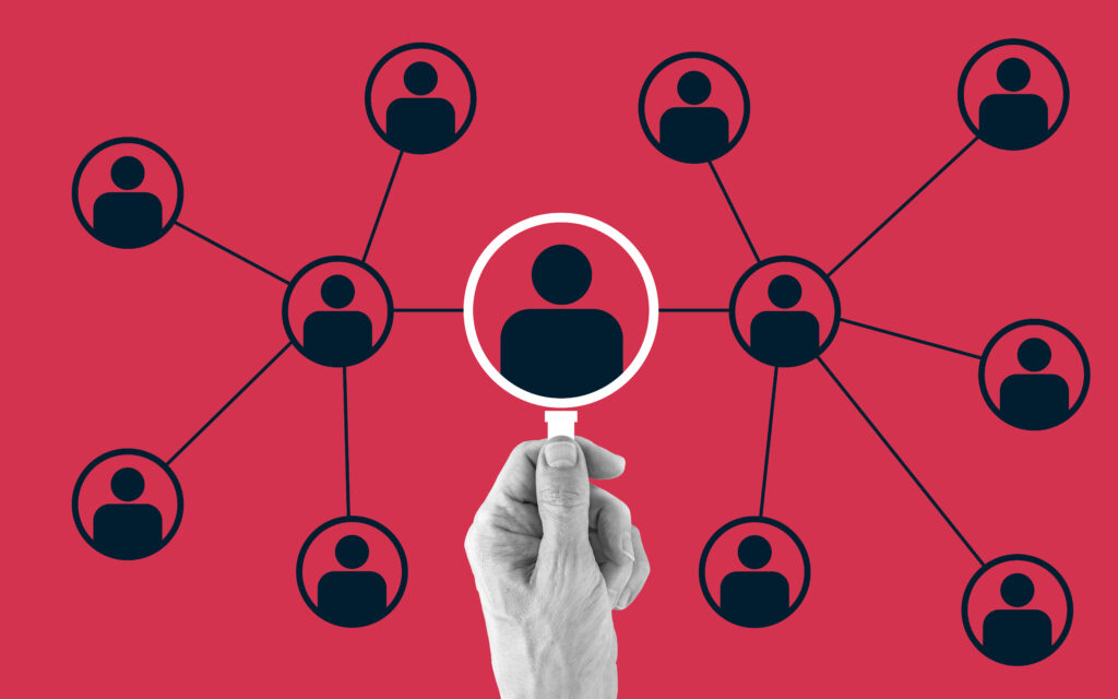 Illustration of a hand holding a magnifying glass over a network of connected user icons. The background is red, and each icon is linked to others, symbolizing connectivity and network analysis.